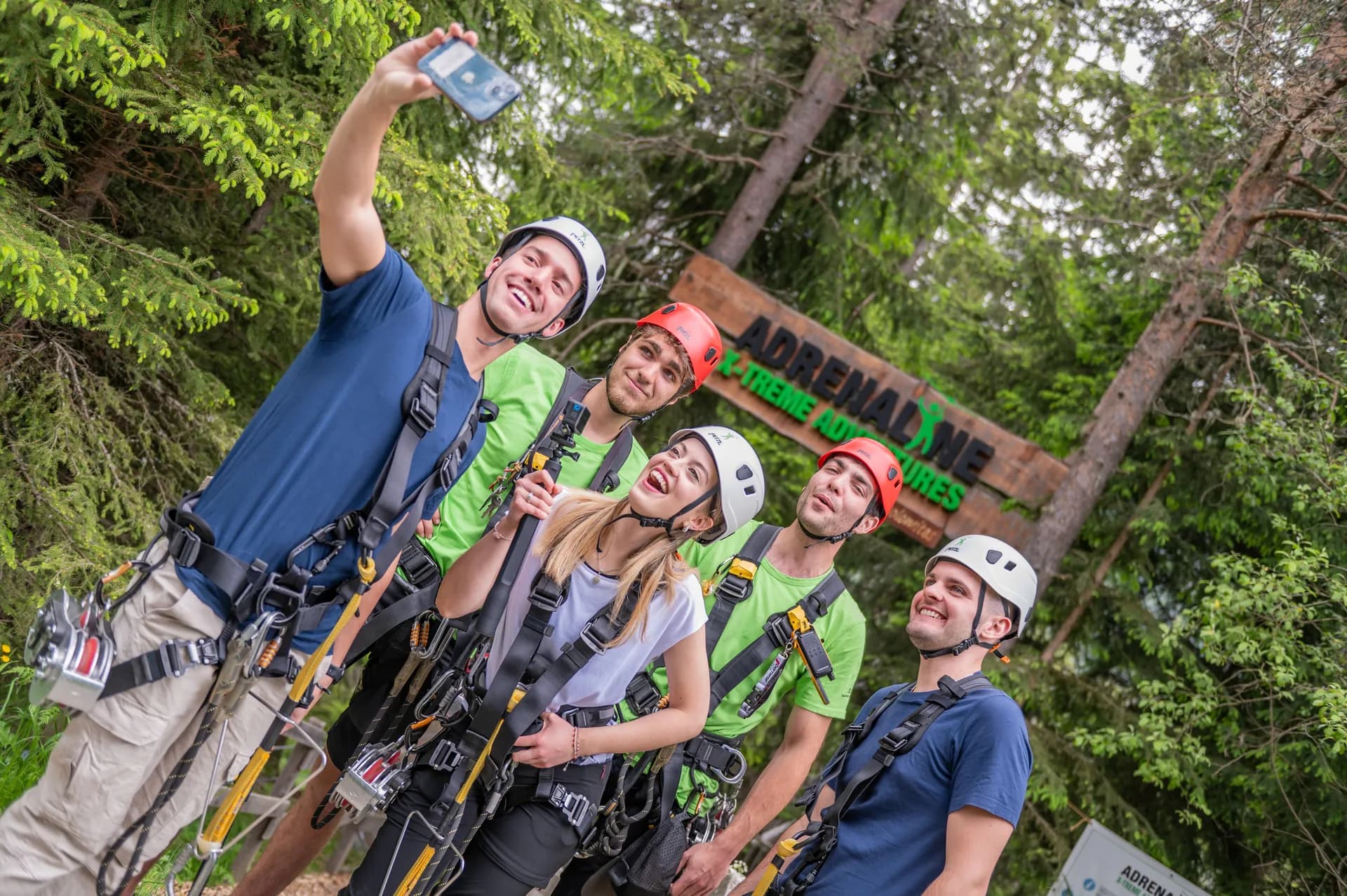 Group selfie in front of Adrenaline sign